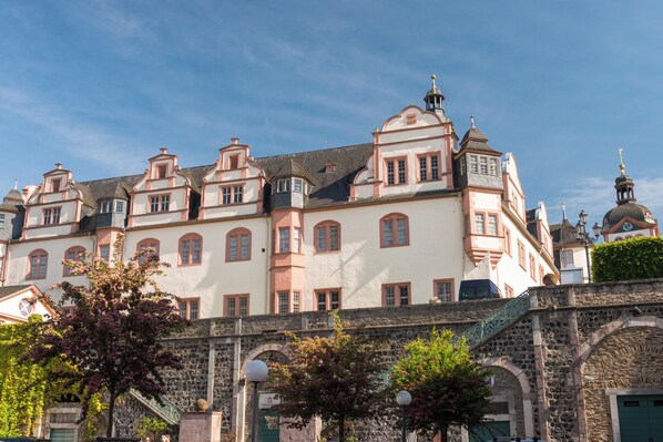 A historic building with multiple windows and a prominent tower.