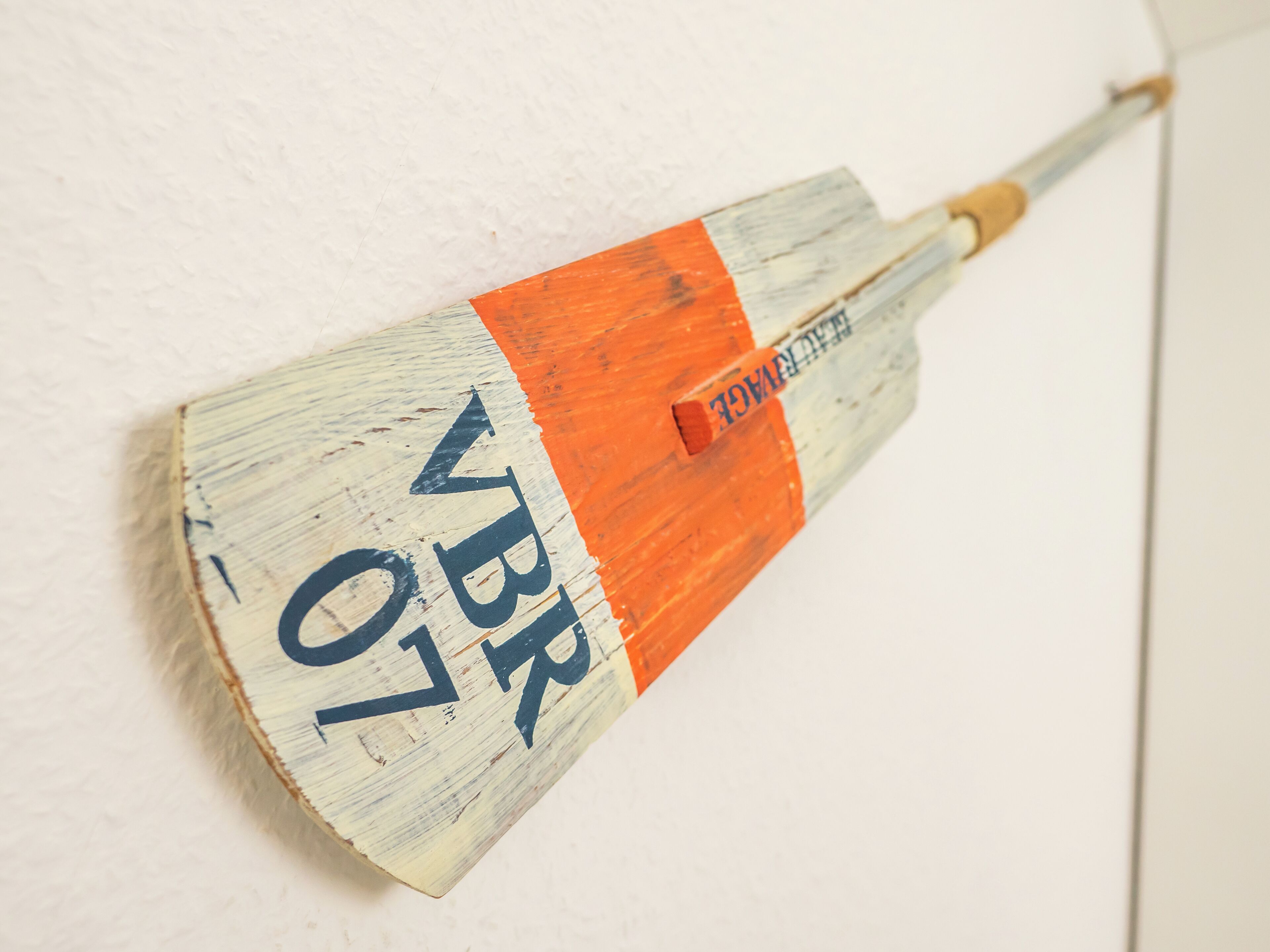 A wall-mounted object resembling a paintbrush with the text "VBR 07" and "REINHABER" on it.