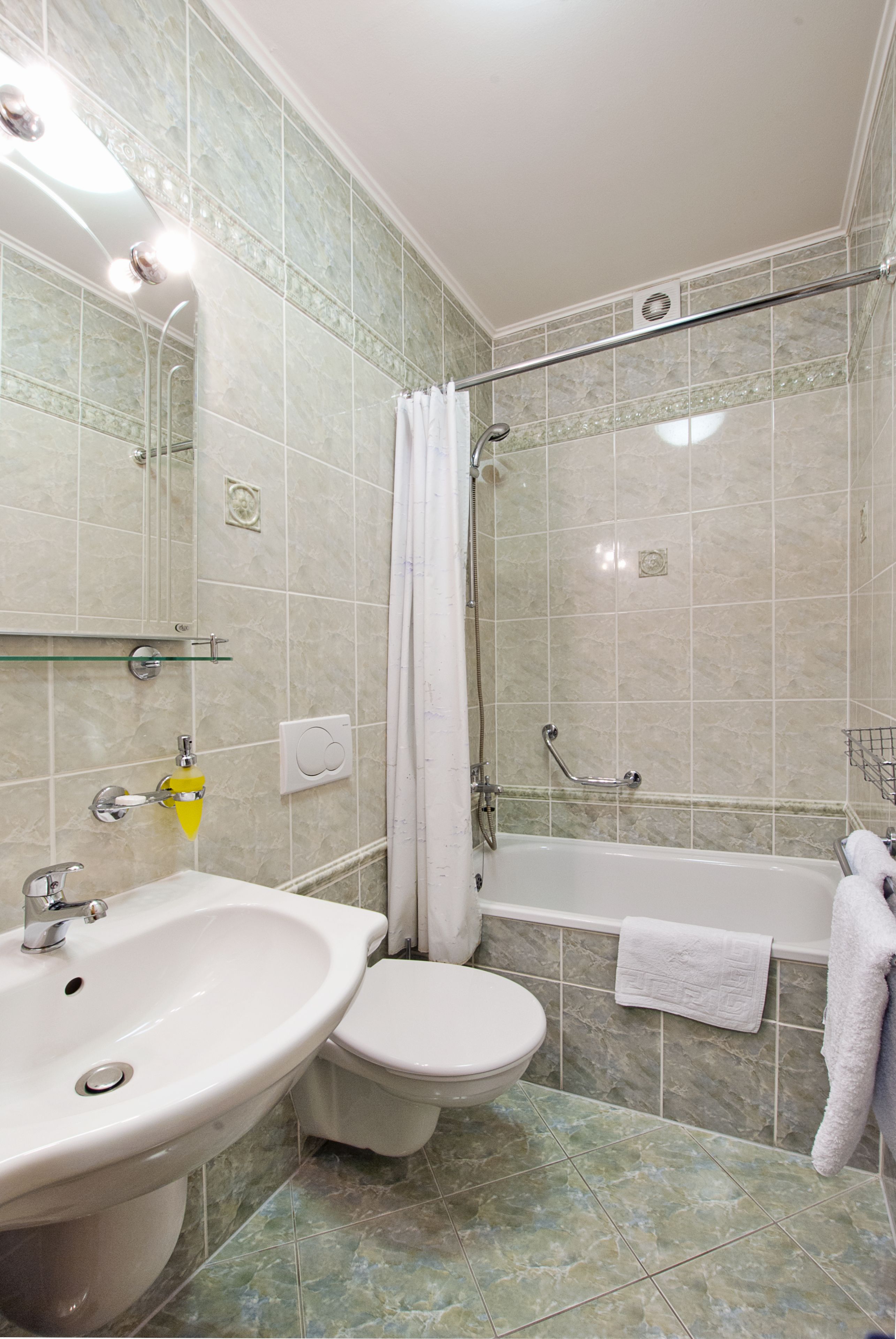 A bathroom with a sink, toilet, bathtub, and shower.