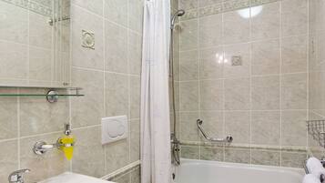 A bathroom with a sink, toilet, bathtub, and shower.
