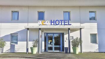 A hotel entrance with a sign reading 'ace HOTEL'.