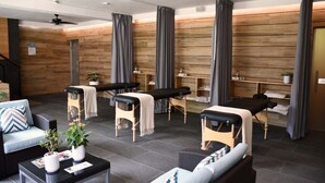 A modern spa area with massage tables, a reception desk, and a seating area with a sofa and coffee table. - Hotel del Pescador (Jocotepec)