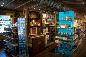 A store with wooden shelves, a blue display, and a sign with the number 406. - Silver Gate Lodging (Silver Gate)