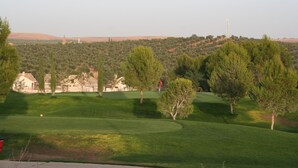 A golf course with a clear view of the surrounding landscape, including hills and trees. - Hostel Layos, Toledo (Layos)