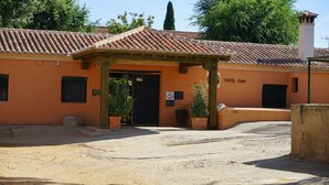 A hostel with a tiled roof, a covered entrance, and a sign indicating it is a hostel camp. - Hostel Layos, Toledo (Layos)