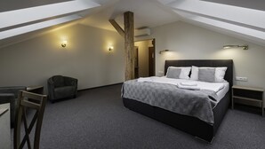 A modern bedroom with a large bed, a desk, and a chair. There are wall-mounted lights and a wooden beam structure. - Statek 1738 (Vsestudy)