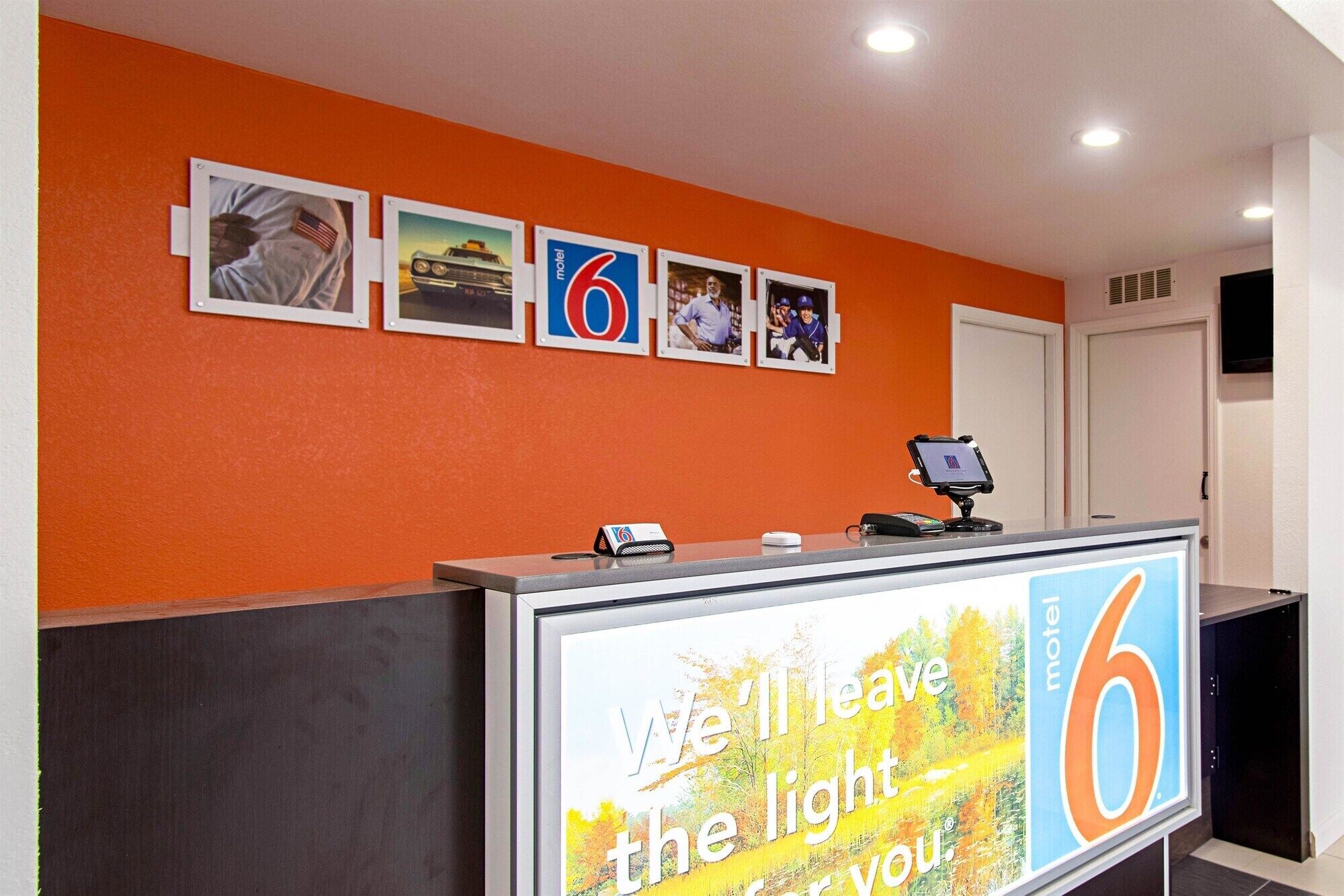 A reception desk with a large sign reading "We'll leave the light for you."