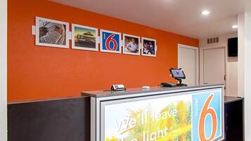 A reception desk with a large sign reading "We'll leave the light for you."