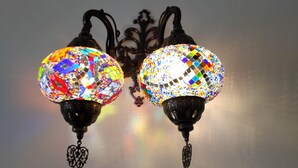 A chandelier with two spherical glass shades and black metal fixtures. - Halikarnas Butik Hotel (Adalar)