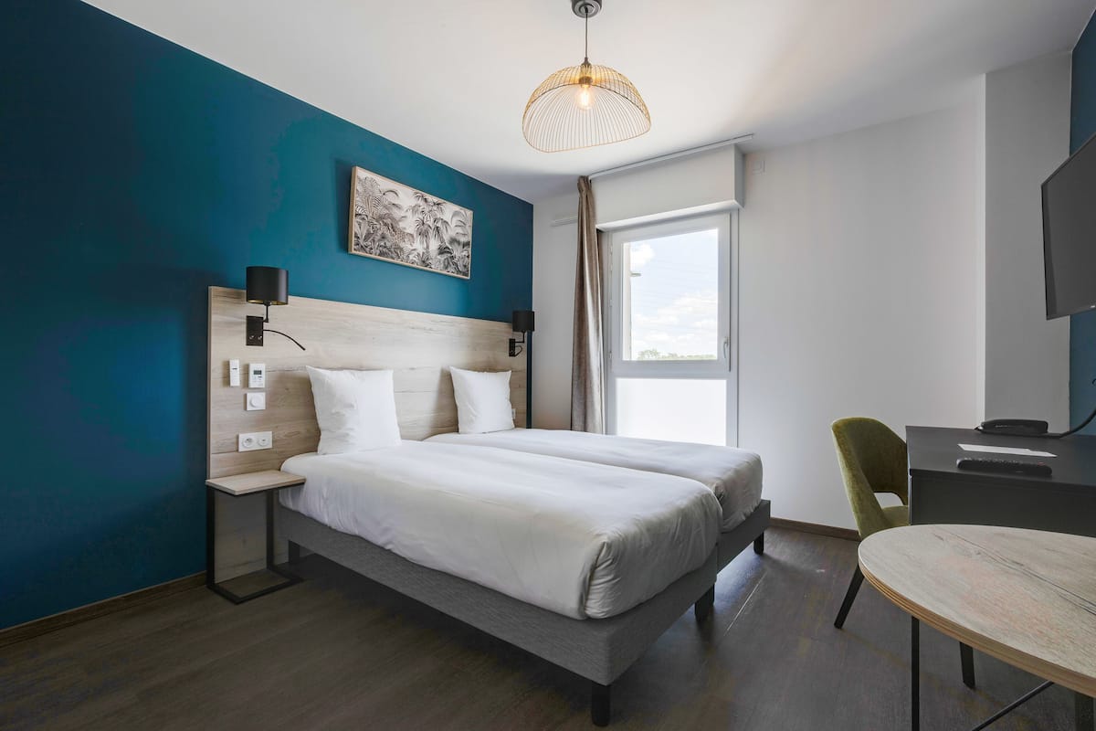 Premium bedding, desk, laptop workspace, soundproofing
