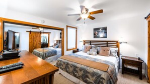 A hotel room with two beds, a desk with a TV, a ceiling fan, and a framed picture on the wall. - Exquisitely appointed-2BR+Loft-walk to Three Kings lift with private hot tub (Park City)