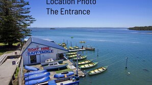 A boat rental facility with a sign reading "Boat Hire" and "Bait Tackle". - The Sands, Unit 5 - The Entrance, NSW (The Entrance)