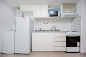 Fridge, microwave, coffee/tea maker, cookware/dishes/utensils