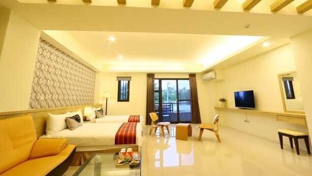 A hotel room with two beds, a sofa, a TV, and a balcony with a view. - Love Back (Ji'an)