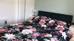 A bedroom with a bed, a nightstand, a lamp, and a wardrobe. - LEE'S CHALET, NORTON PARK, Dartmouth, 2 bedrooms, sleeps 4 (Dartmouth)