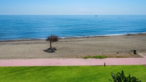 A beach with a clear view of the sea, a solitary tree, and a paved walkway. - 322 Luxury Apartments-Estepona, 2 b'room Apt, 28c All Year 20m Heated Pool (Estepona)