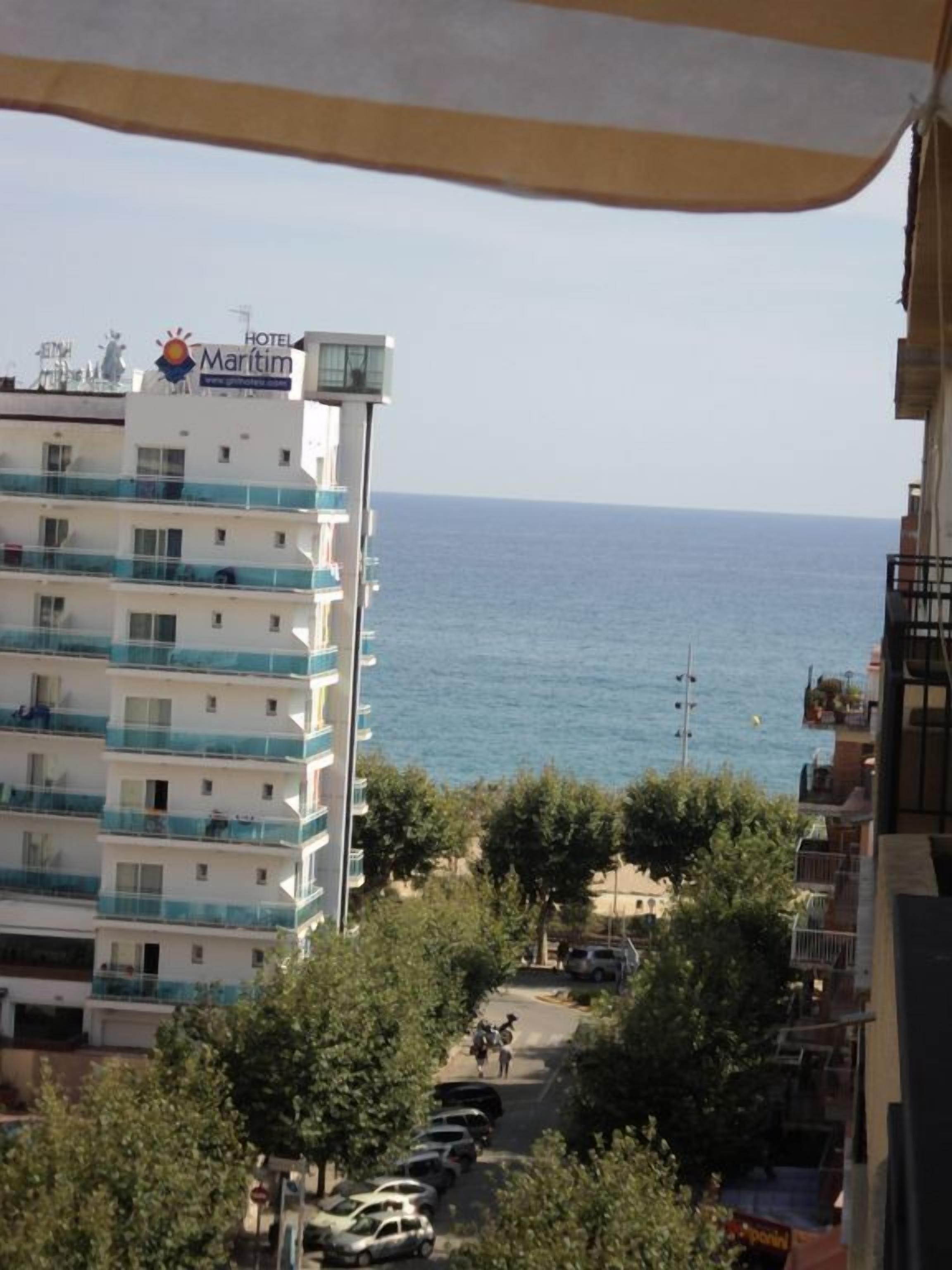 Ein mehrstöckiges Hotel namens 'Hotel Maritim' mit Balkonen mit Blick auf das Meer.