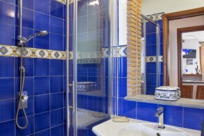 A bathroom with blue tiles, a shower, a sink, and a mirror. - MyExclusiveItaly - Luxury Villa with breathtaking Seaview,pool,BBQ (Sorrento)