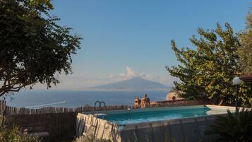 Una piscina con vista su una montagna e il mare.