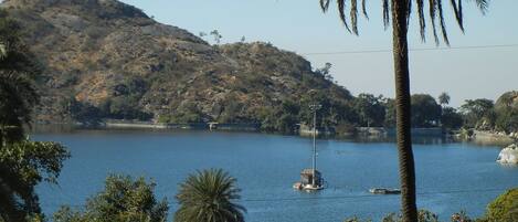 A calm lake with a small island and a lighthouse.