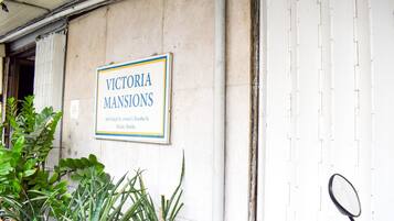 A sign for "Victoria Mansions" with an address.