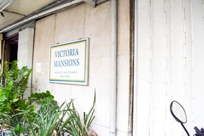 A sign for "Victoria Mansions" with an address. - Victoria Mansions (Manila)
