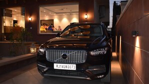 A black SUV parked in front of a building with a large window. - Hotel The Balam (Luni)