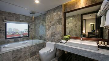 Suite, 1 King Bed, City View | Bathroom | Combined shower/tub, free toiletries, hair dryer, bathrobes