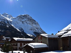 A mountain village with snow-covered buildings and a prominent mountain in the background. - 3-Room Apartment Near Cable Car with Closed Garage (Pralognan-la-Vanoise)