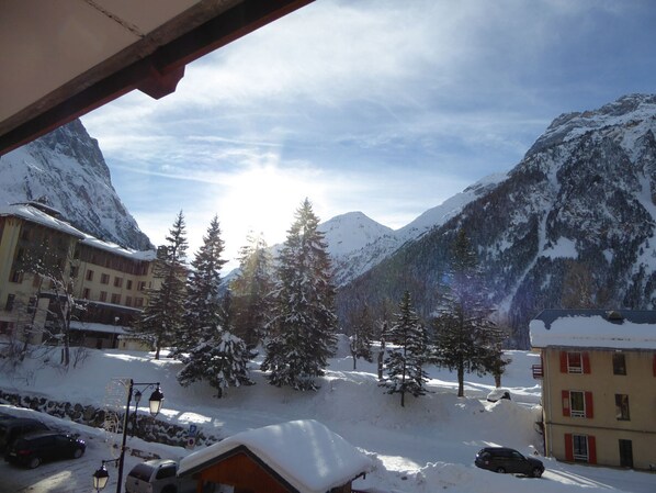 A mountain view with snow-covered buildings and trees.