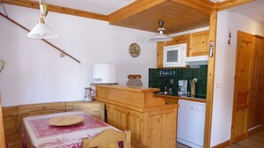 A compact kitchen with wooden cabinets, a microwave, a coffee maker, and a sink. - Beautiful apartment in Pralognan center with parking (Pralognan-la-Vanoise)