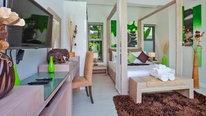 A modern hotel room with a bed, bedside table, TV, and a desk with a chair. - Isawan 2BR Salt Pool Villa in Baannaraya (Rawai)
