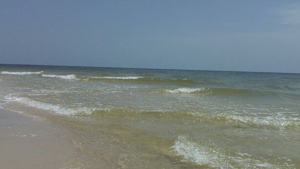 A beach with clear water and gentle waves. - Let The Waves Hit Your Feet & Sand Be Your Seat! Step Right Out To The Pool! (Biloxi)