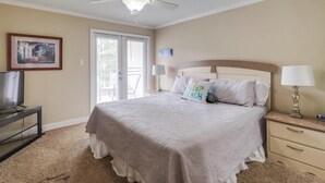 A bedroom with a bed, a ceiling fan, a TV, and a window. - Beach Days = Best Days!   Fishing, Sunning, Beaching, Boating, Swimming=FUN!! (Biloxi)