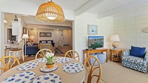 A dining area with a round table, chairs, and a hanging light fixture. - SeaPines, Walk to the Beach Club, Golf view, 2 free bikes (Hilton Head Island)