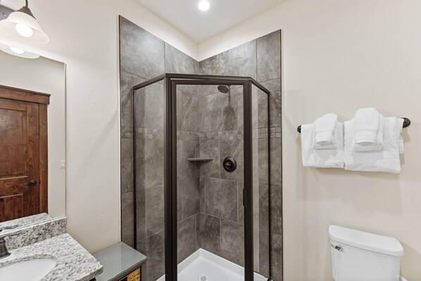 A bathroom with a shower enclosure, a toilet, and a sink. - Shuttle Nearby, Minutes Away from Gondola, Shopping, Restaurants, and More! (Keystone)