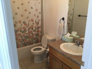 A bathroom with a toilet, sink, and shower curtain. - Tranquil Retreat with Gorgeous near 360-degree Mountain Views! (Rio Rico)