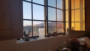 A kitchen with a window, a sink, and various kitchen items. - Tranquil Retreat with Gorgeous near 360-degree Mountain Views! (Rio Rico)