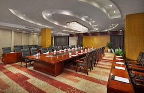 A conference room with a long table, multiple chairs, and a carpeted floor. - Zhangjiajie Huatian Hotel (Zhangjiajie)