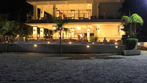 A two-story building with a balcony and outdoor seating area.