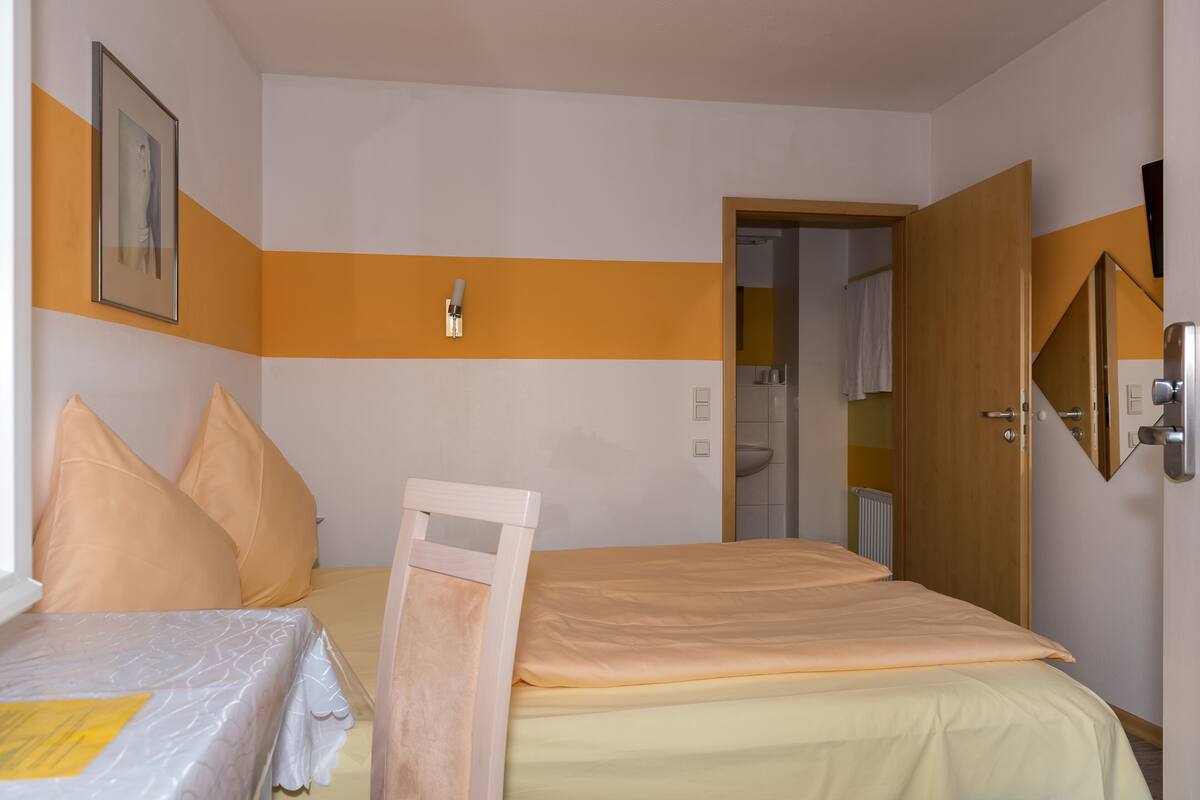 Premium bedding, desk, laptop workspace, blackout drapes