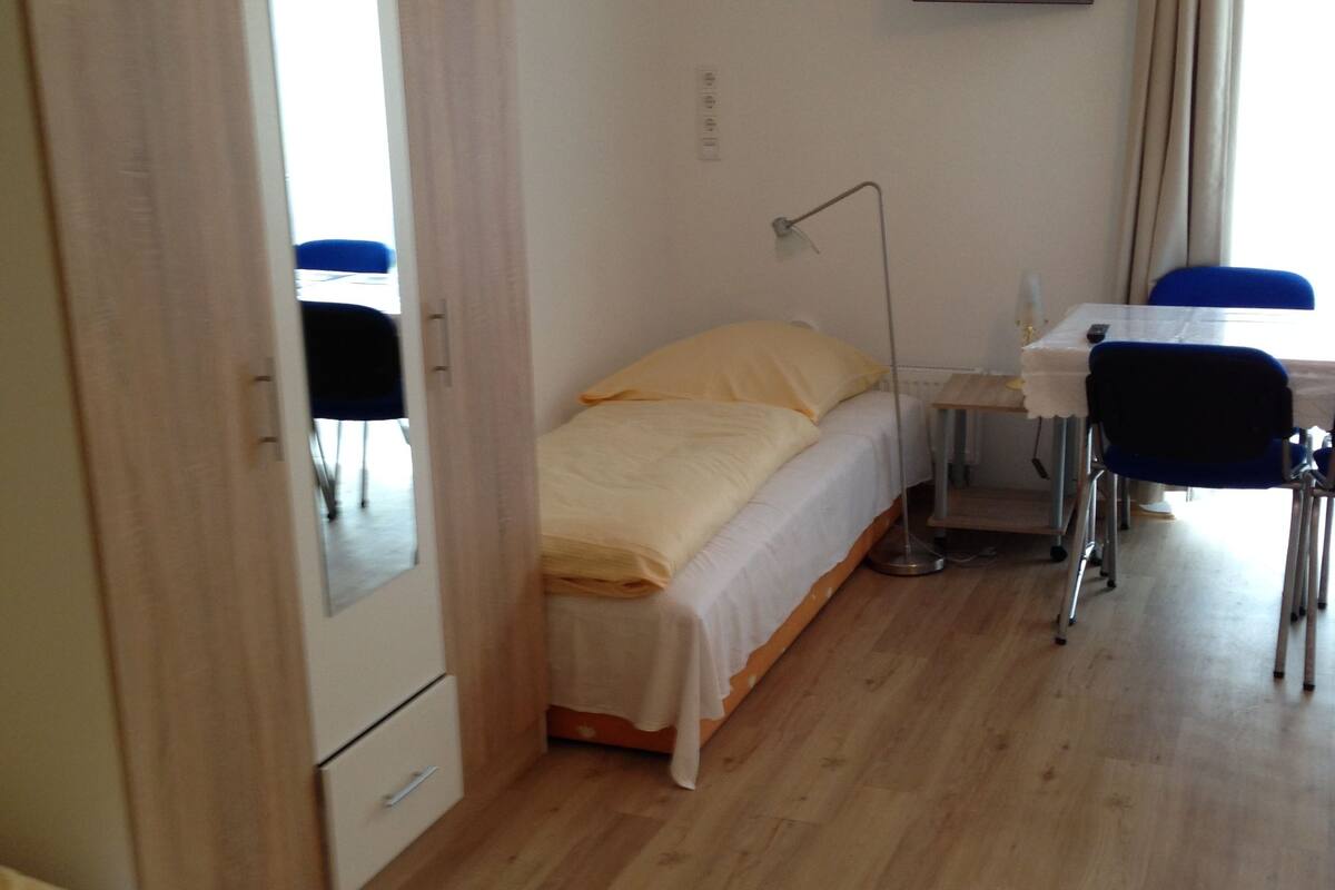 Premium bedding, desk, laptop workspace, blackout drapes