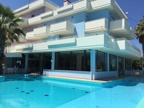 Seasonal outdoor pool, open 10:00 AM to 7:00 PM, pool umbrellas