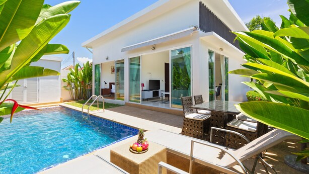 A modern house with a swimming pool, outdoor furniture, and tropical plants. - Tropical Stay at 2BR Pool Villa Greens 8 (Rawai)
