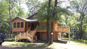 A wooden cabin with a porch, stairs, and a deck. - Northwoods Wisconsin Retreat!!  Newly built cabin sleeps 12 comfortably.   (Trego)