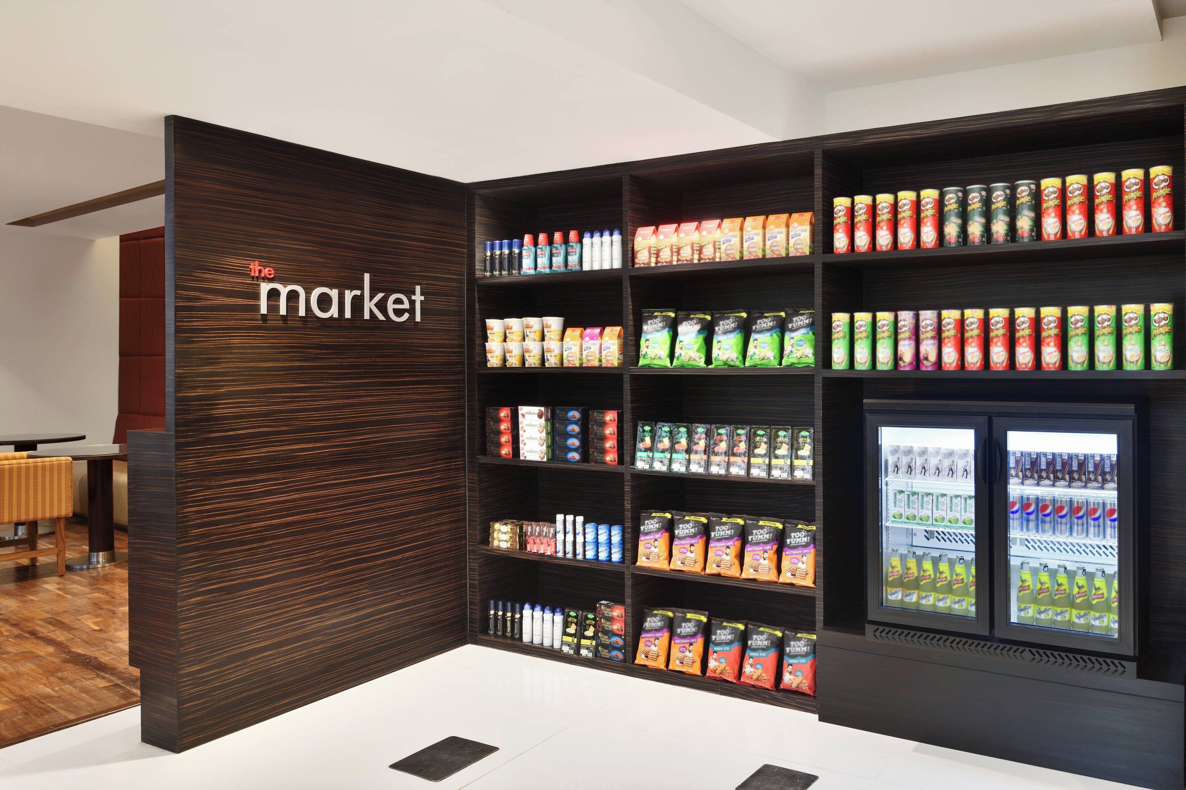 A modern retail display with shelves stocked with snacks and beverages.