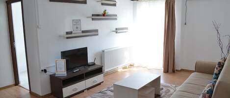 Departamento Prestigio, 1 habitación | Sala de estar | Televisión de pantalla plana