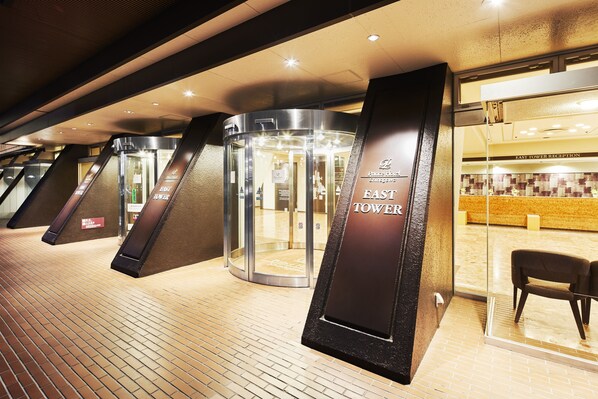 A hotel entrance with revolving doors and a reception area. - Shinagawa Prince Hotel East Tower (Tokyo)