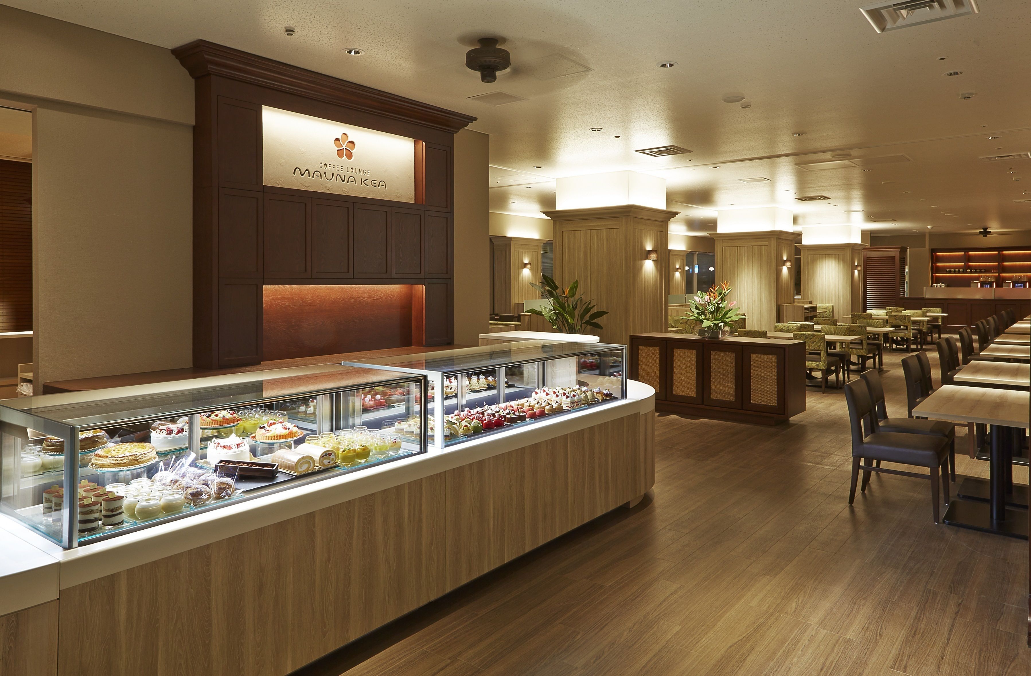 A buffet area with a variety of desserts and a coffee lounge sign.