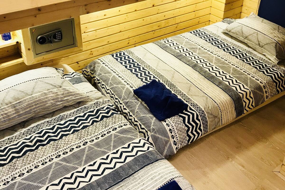 A wooden bunk bed room with a 'Stand Tall Darling' sign above.